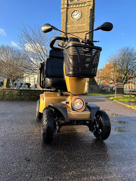 One of our mobility scooters in front of the clock tower in Folkestone