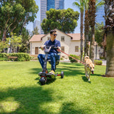 A man walking his dog whilst riding his ATTO Sport mobility scooter