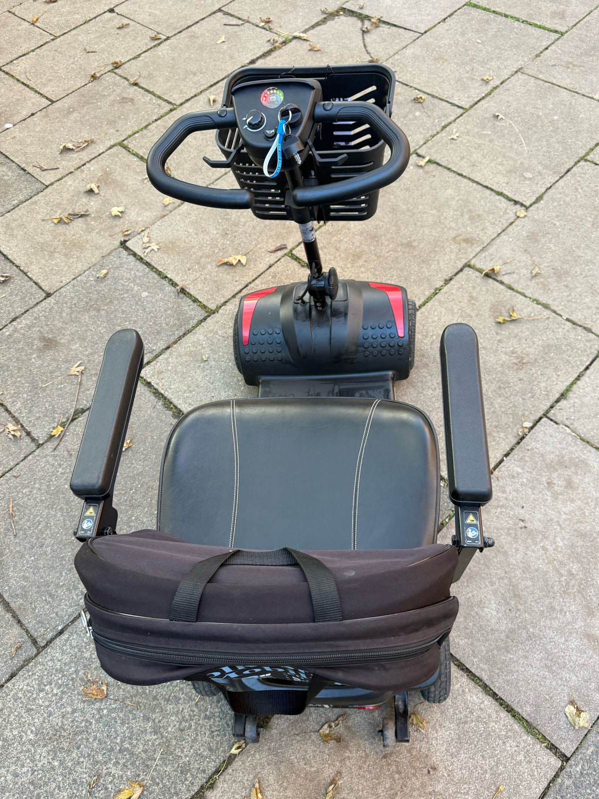Pre-owned Rascal Vie 4mph boot scooter in red - top view of tiller and seat